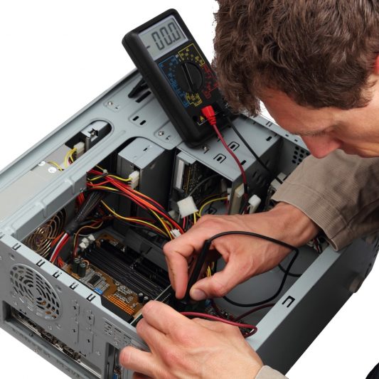 Professinal repairing a PC with measuring instrument